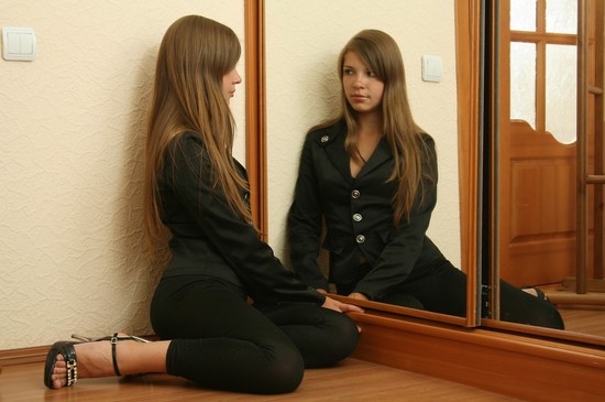 Anastasya in and out of her pajamas in front of the mirror